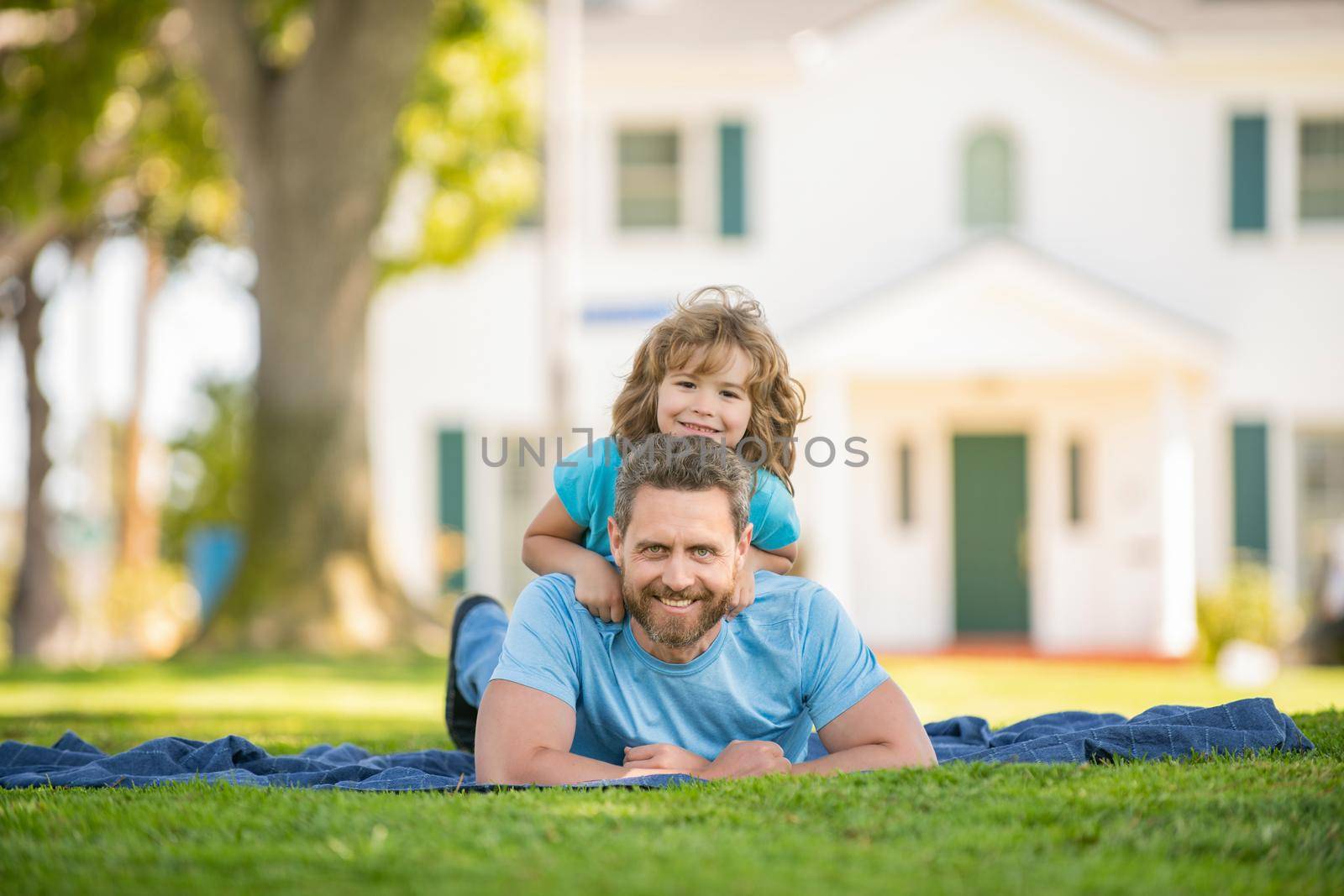 dad with kid on summer day. parenting and fatherhood. fathers day. happy father and son having fun outdoor. family value. childhood and parenthood. parent relax with little child boy on grass.
