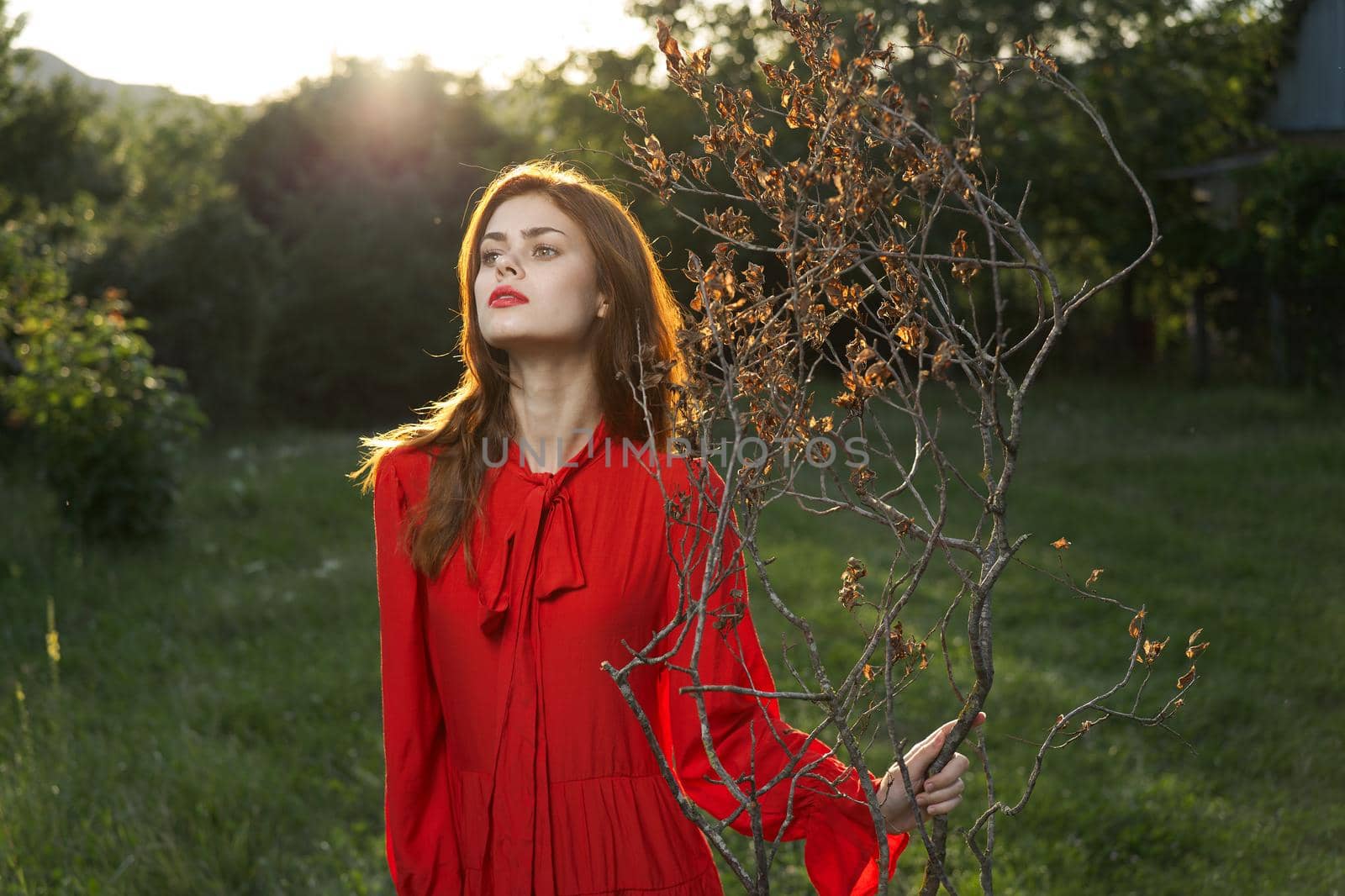 attractive woman in red dress outdoors fresh air summer. High quality photo