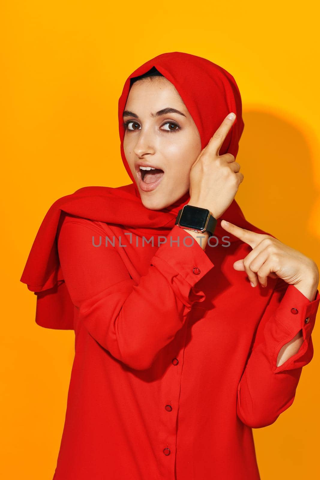 woman in red hijab with clock in hands technology emotions studio lifestyle by Vichizh