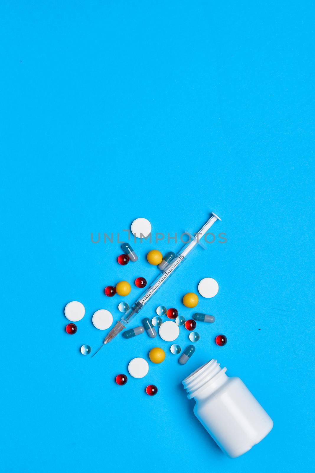 medicine jar Pharmaceuticals medicines syringe blue background by Vichizh