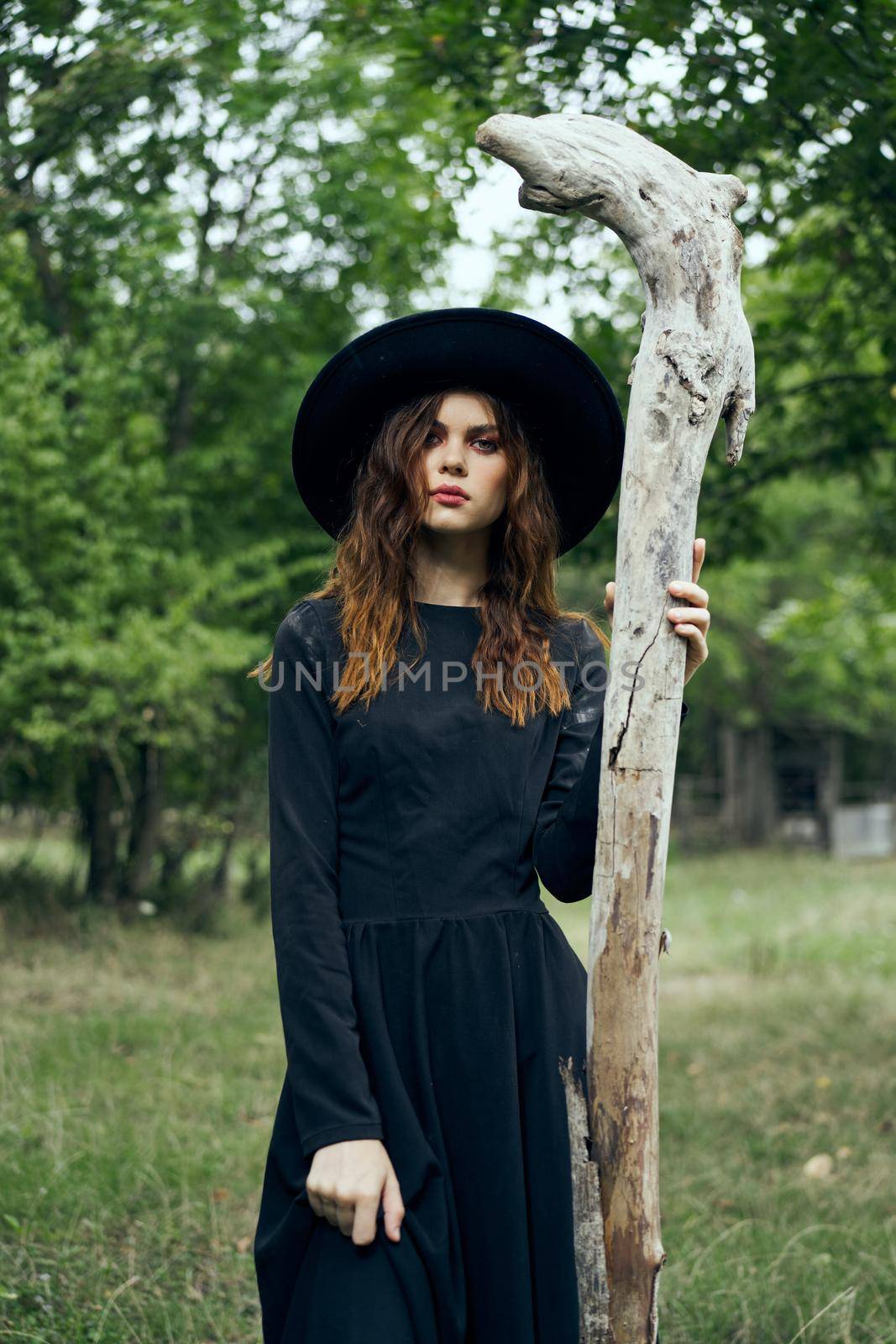 woman in witch costume fantasy magic forest posing. High quality photo