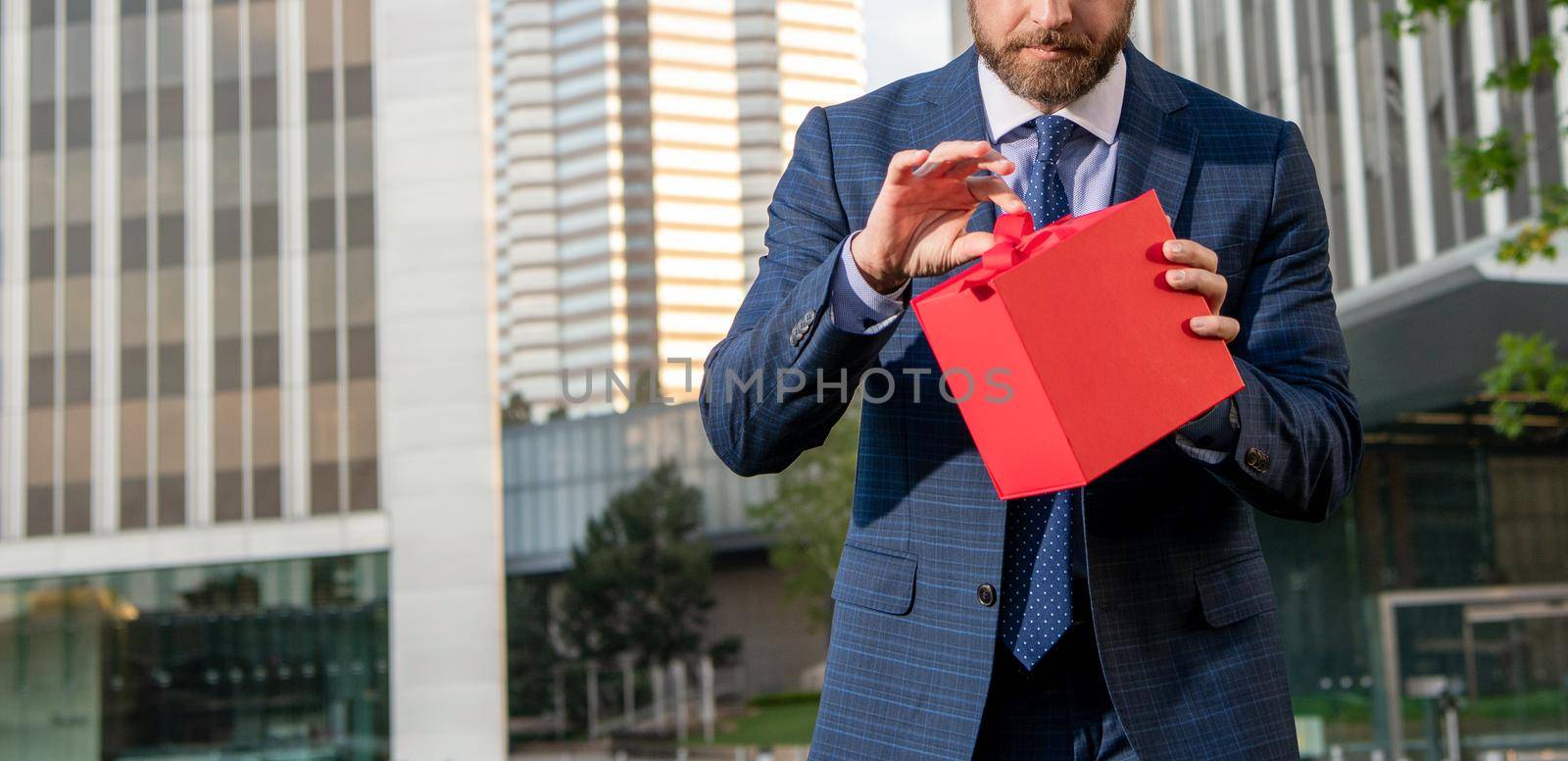 entrepreneur hold birthday gift. shopping concept. mens day. cropped businessman open box. by RedFoxStudio