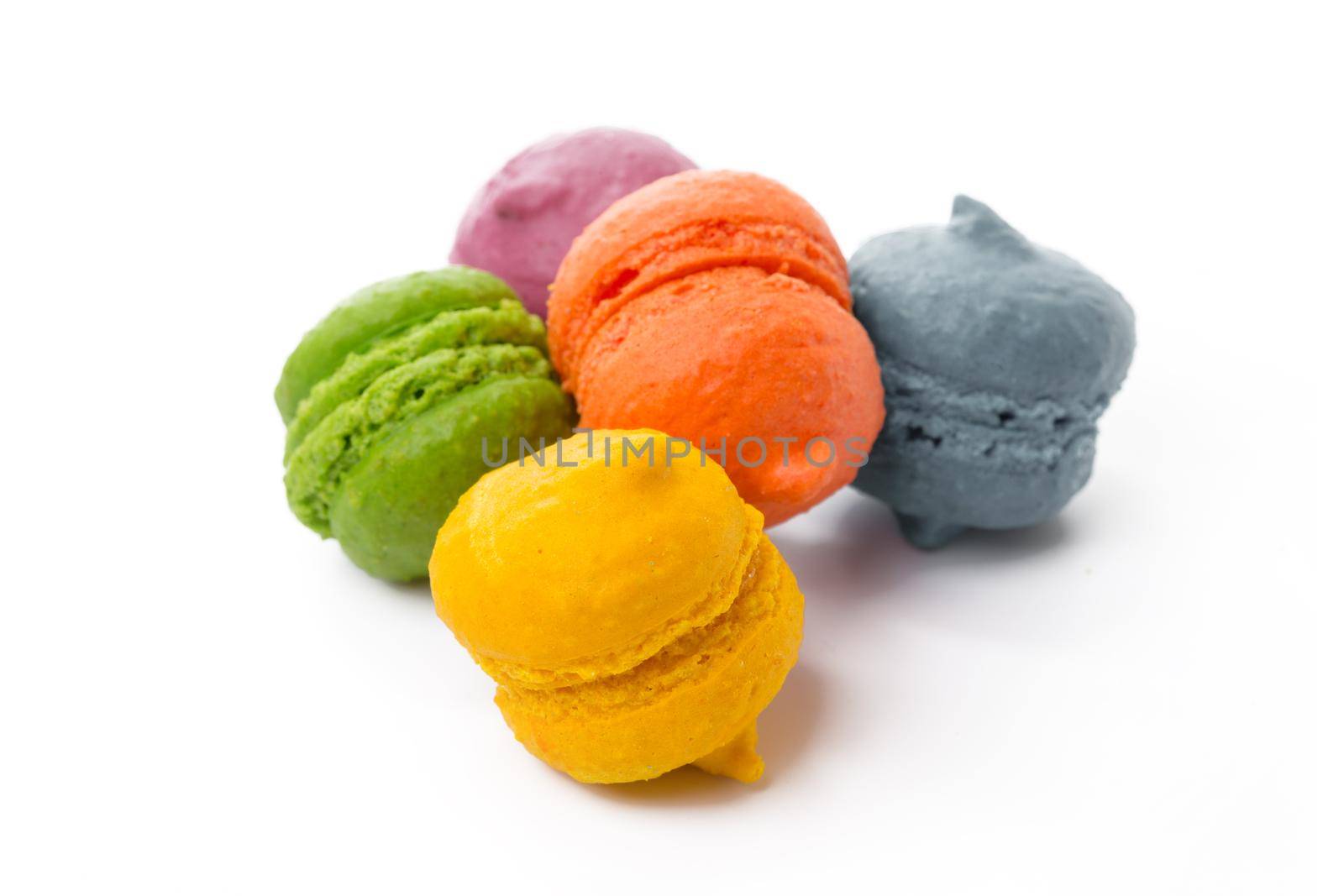 Pile of colorful meringue cookies isolated on white background