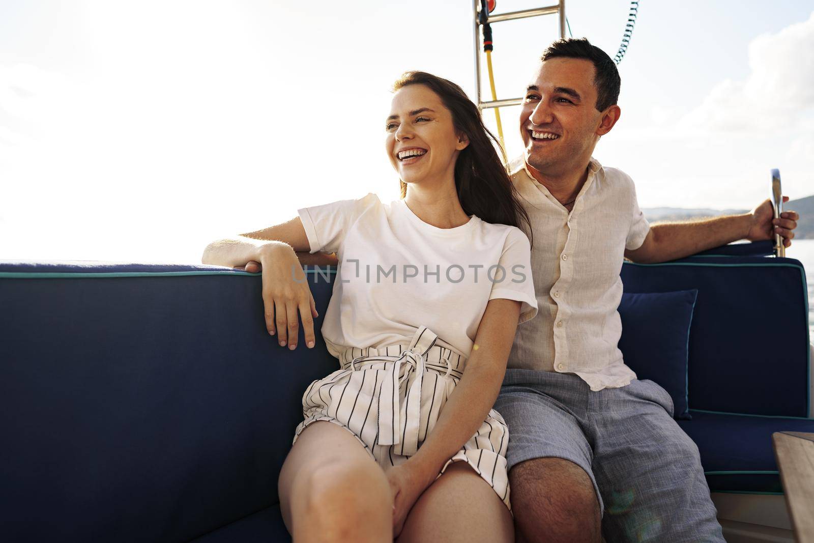 Happy couple in love on a yacht in summer on romantic vacation