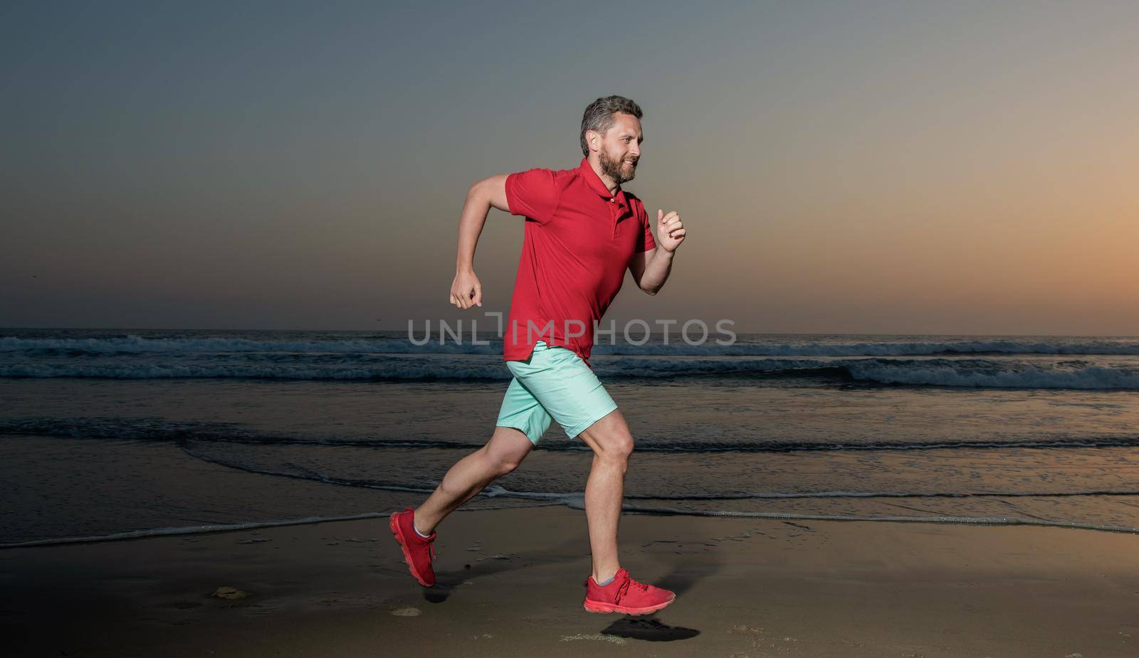 sportsman sprinter running on sunrise summer beach at ocean, athlete by RedFoxStudio