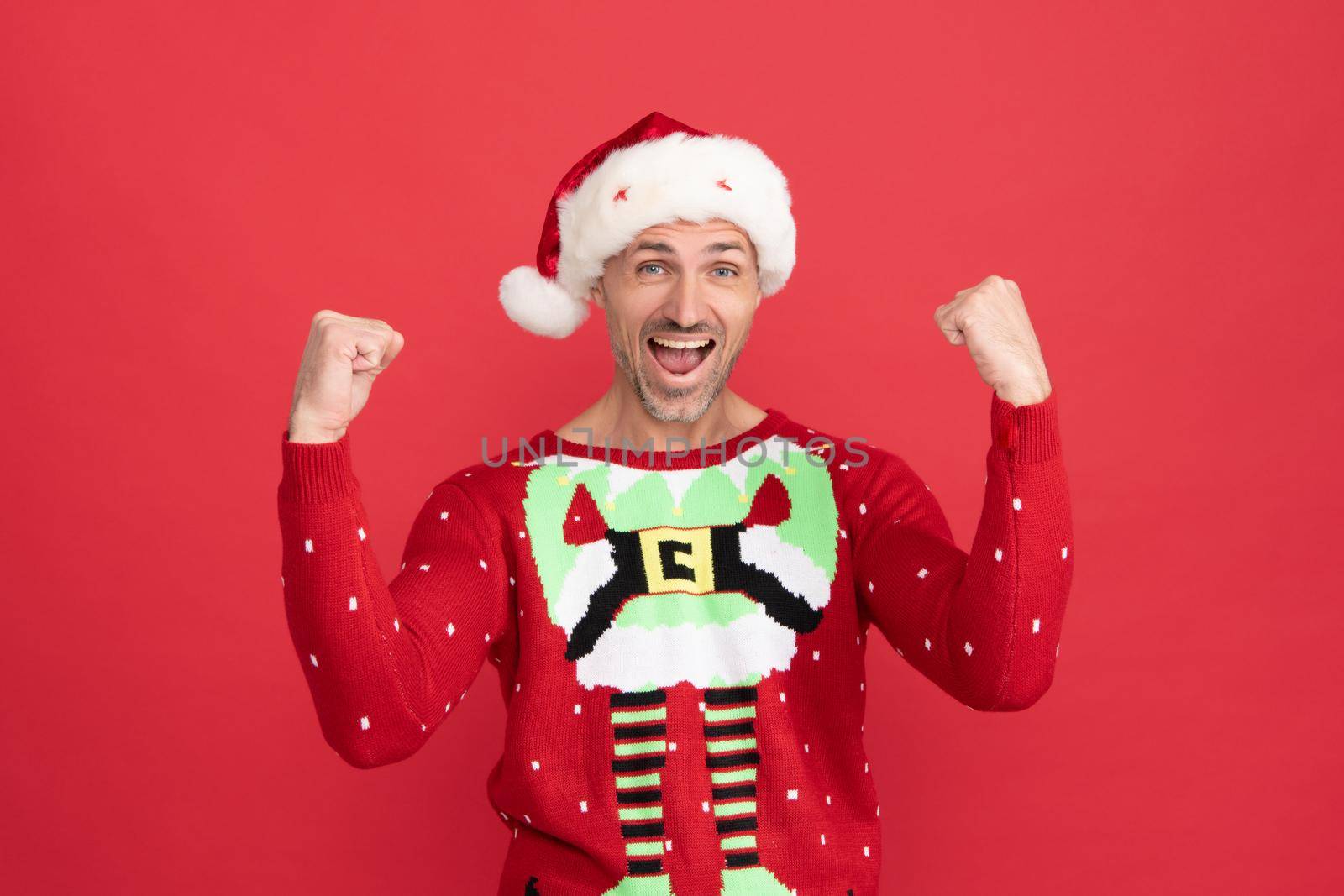 Winner announced. Happy santa man. Christmas elf scream making winning gesture. Merry Christmas by RedFoxStudio