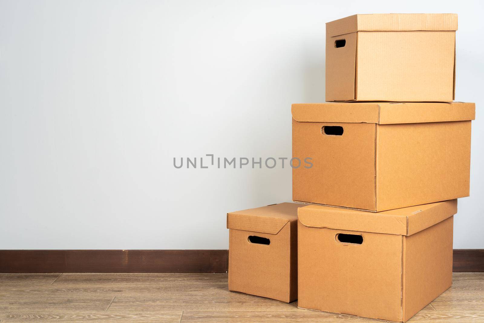Group of brown carton boxes on wooden floor. Close up.