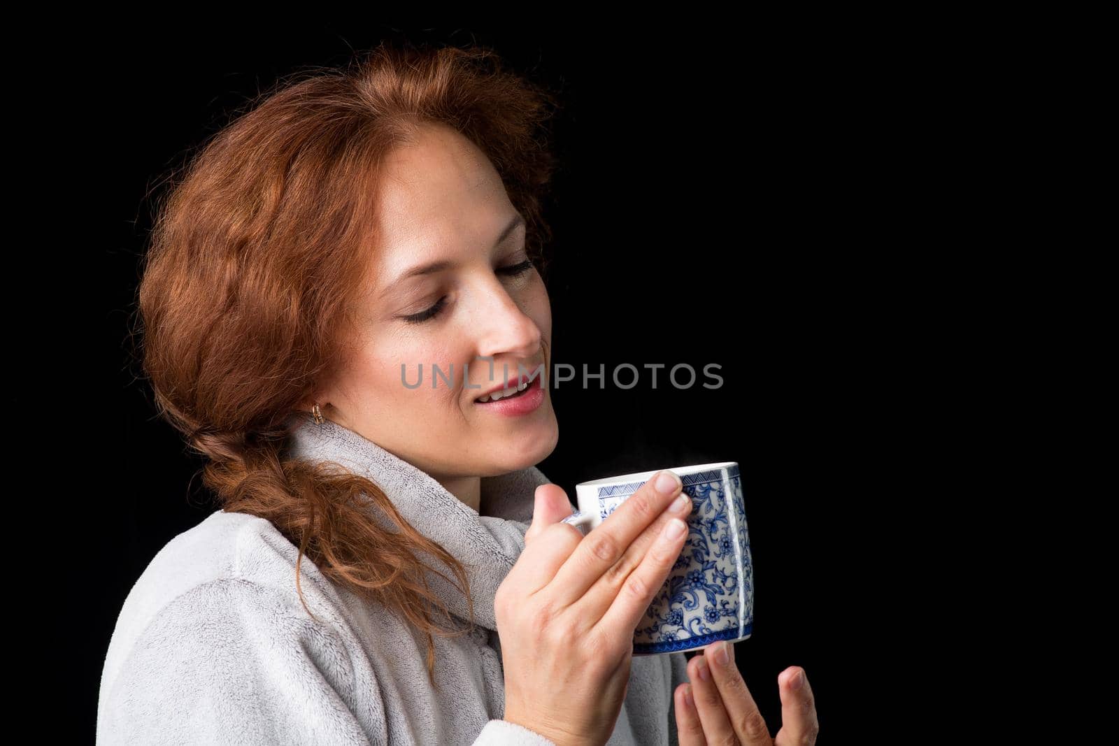 Smiling woman holding porcelain mug. Photo session in the studio by kolesnikov_studio