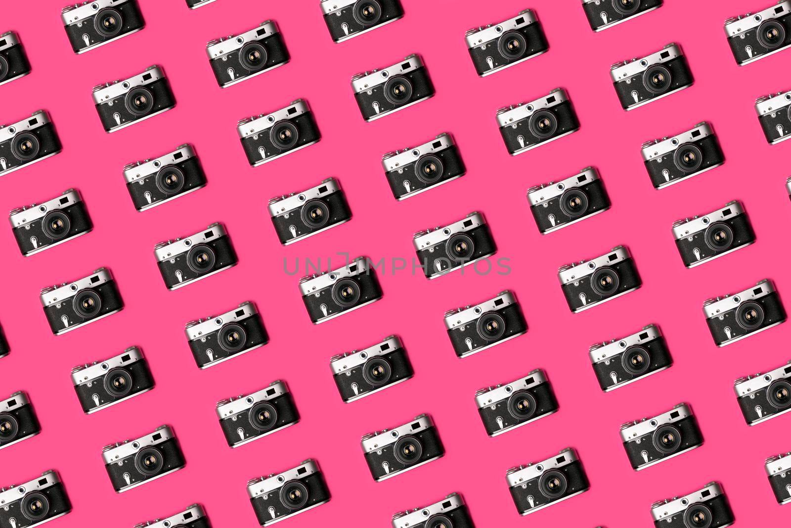 Retro camera isolated on bright pink background creative pattern. Pop art concept. Flat lay in minimal style