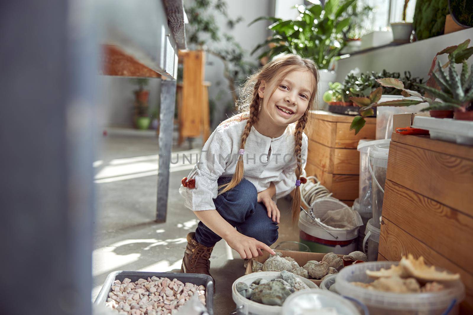 Portrait of a young happy smiling caucasian girl. Flourist shop with different kinds of dryed flowers. by Yaroslav_astakhov