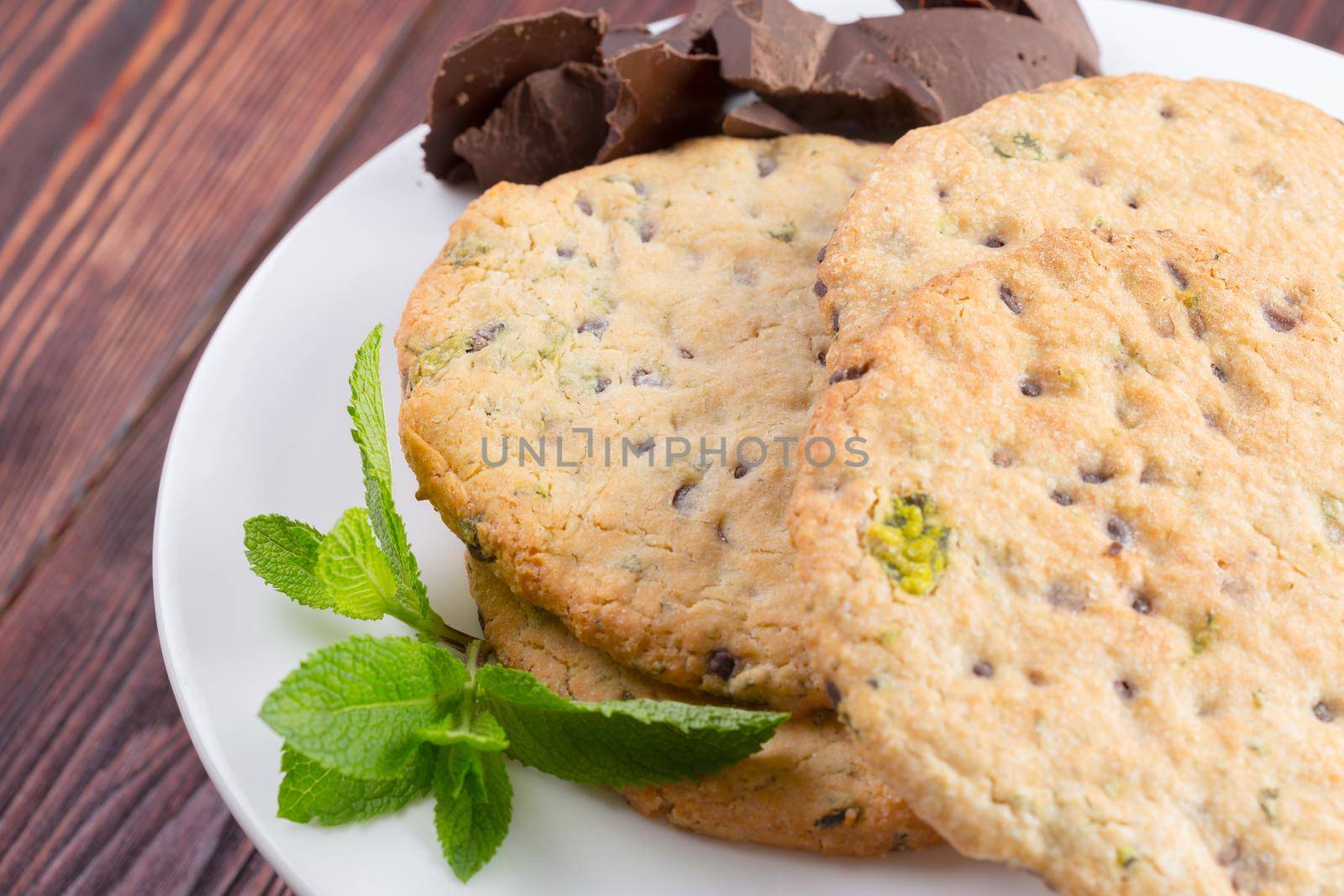 Oat cookies served on dark wooden table close up