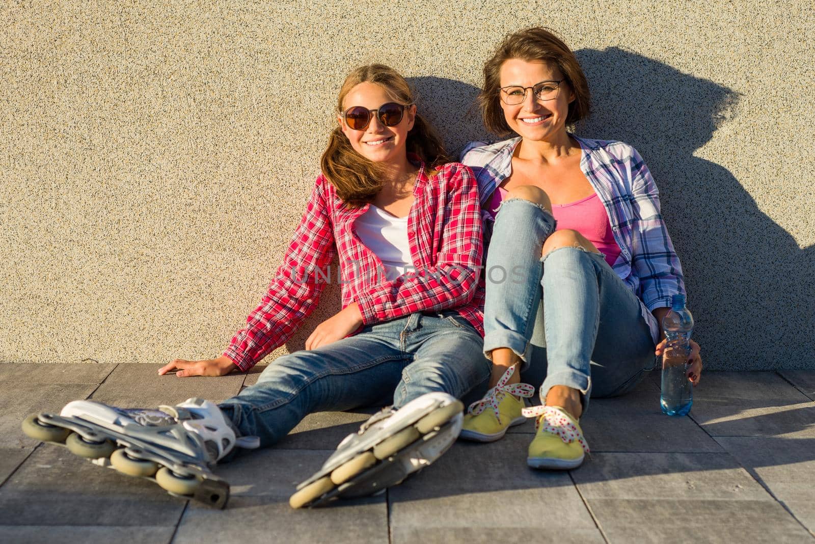 People, motherhood, family, summer. - Happy mother and daughter talking outdoors