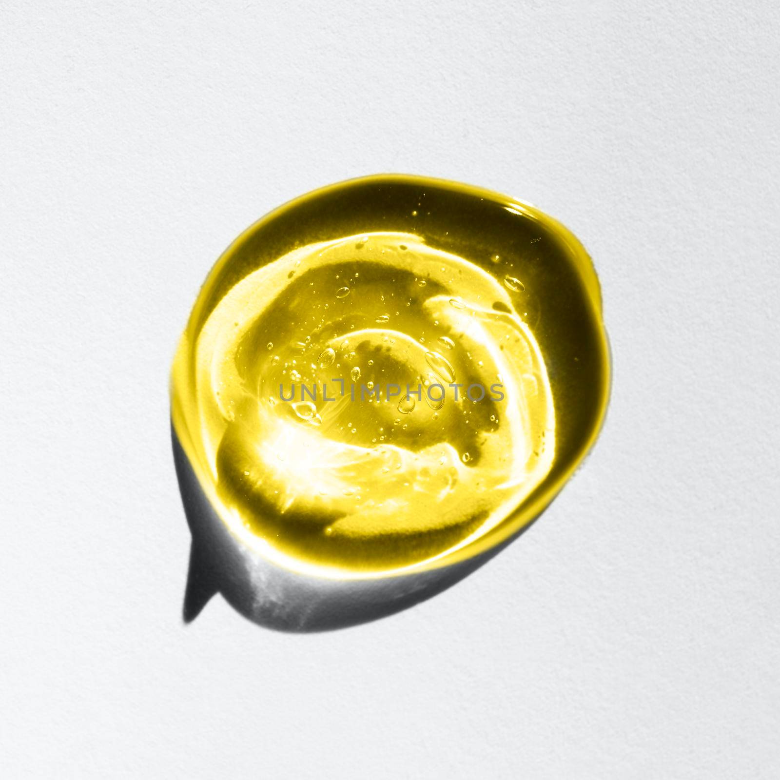 Clear yellow and gray liquid gel drop or smear isolated on white background. Demonstrating trendy colors 2021 - Gray and Yellow. Top view. Body and face care spa cosmetic concept. Serum texture.
