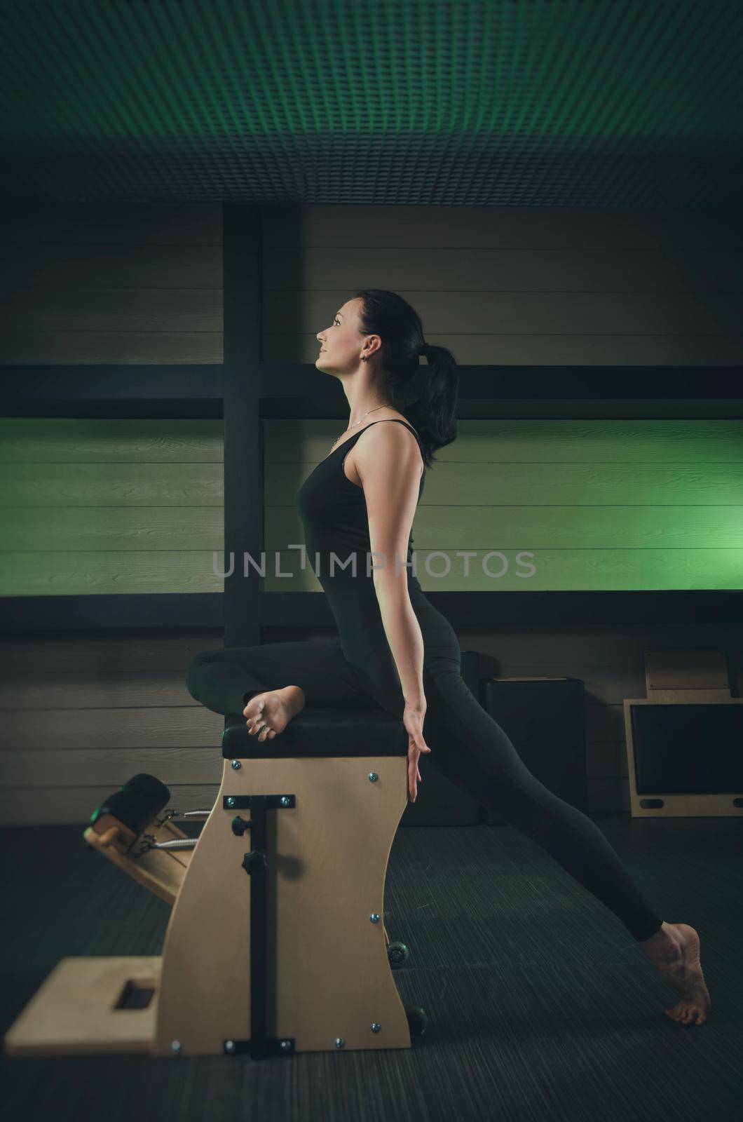 a woman is engaged in Pilates. fitness and sports by Rotozey
