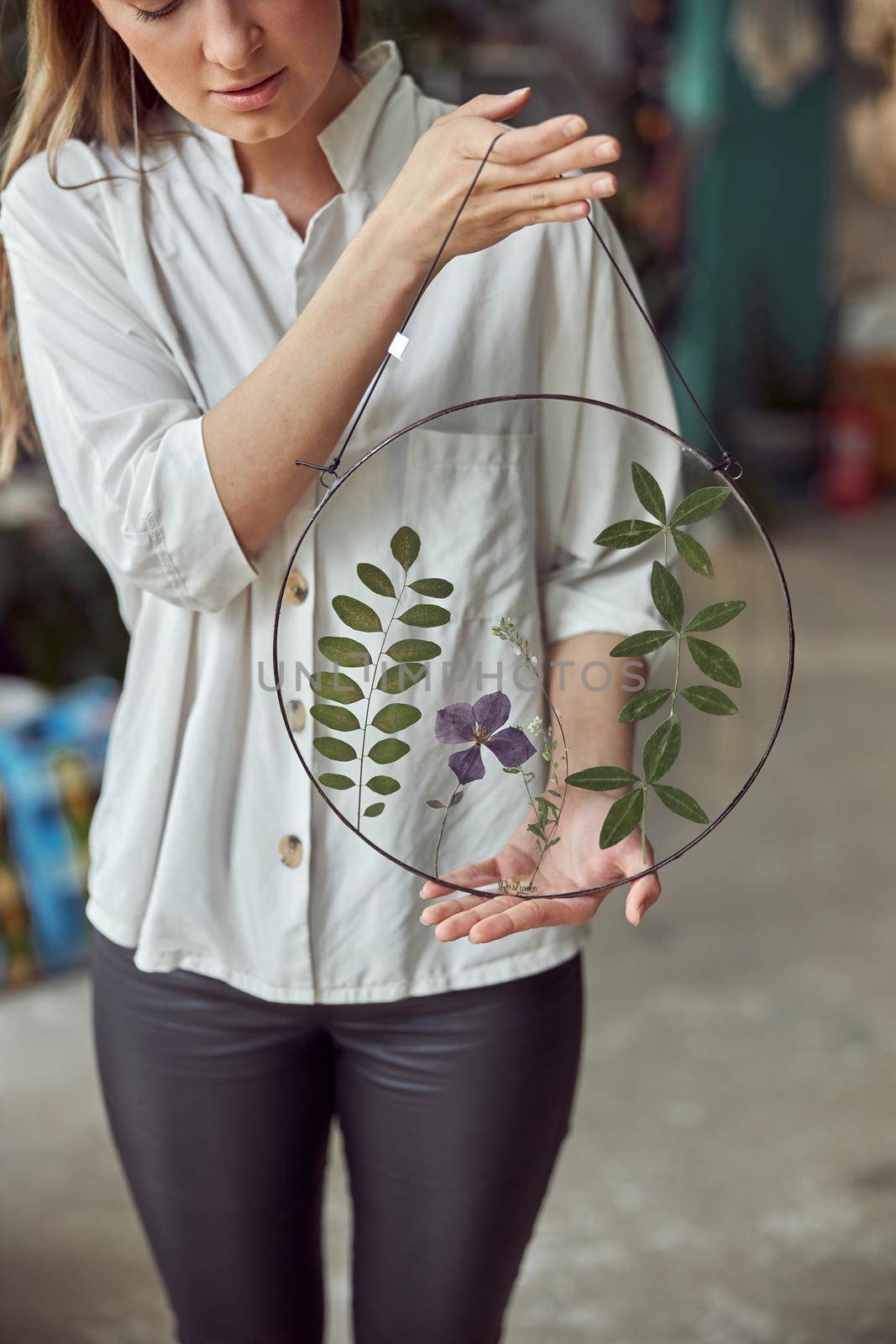 Young female caucasian woman florist is holding her work