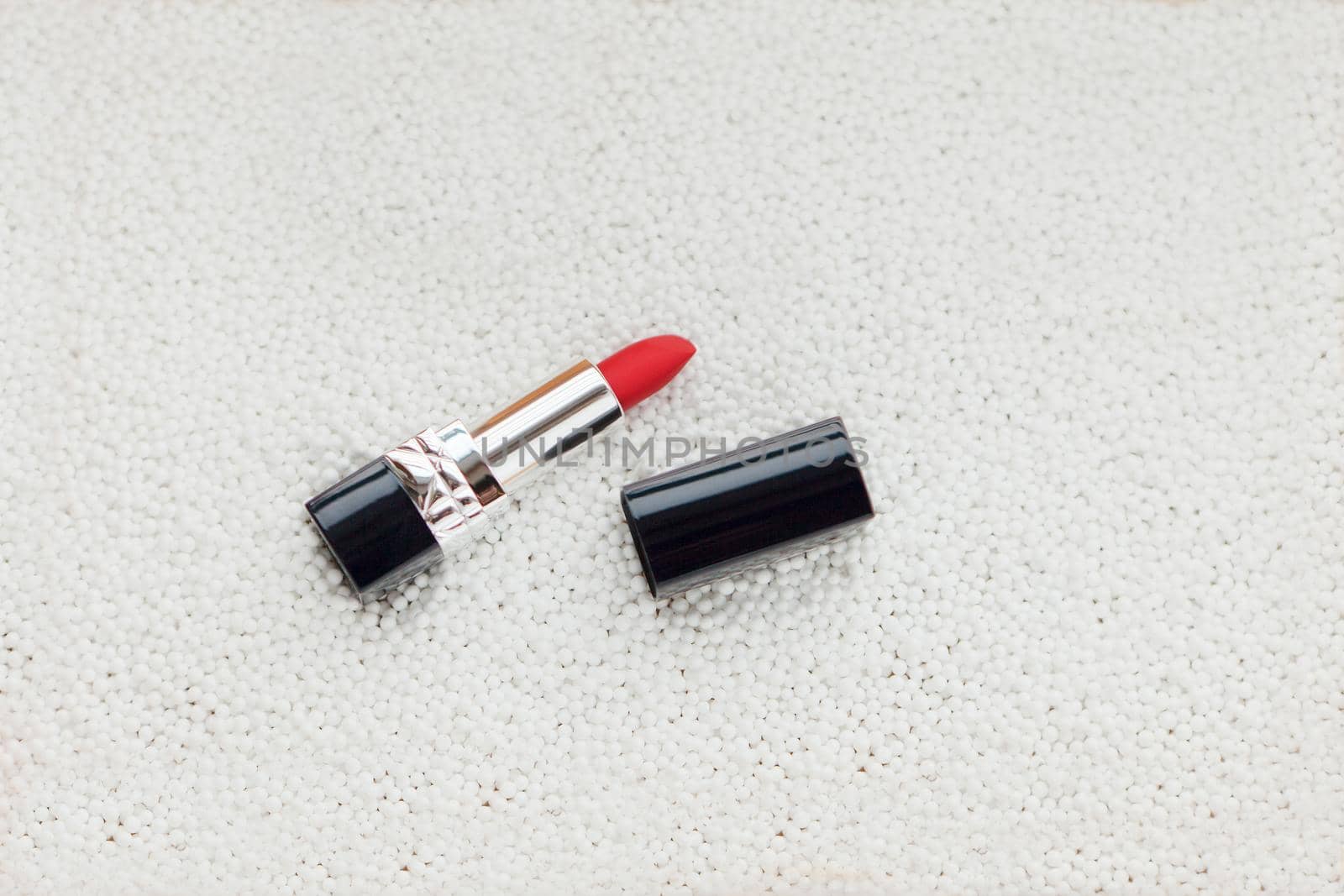 red lipstick on white bubbles with white background. flat lay image by julija