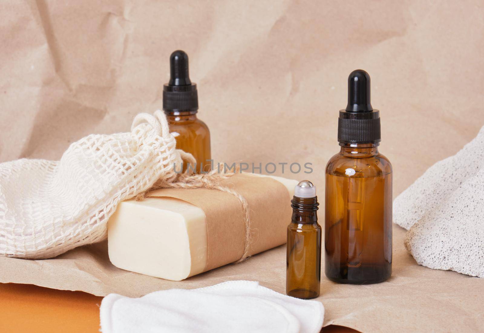 Set of natural organic SPA beauty products amber bottle oil, homemade soap, reusable cotton eco-friendly facial sponges and glass cosmetic container with roll-on