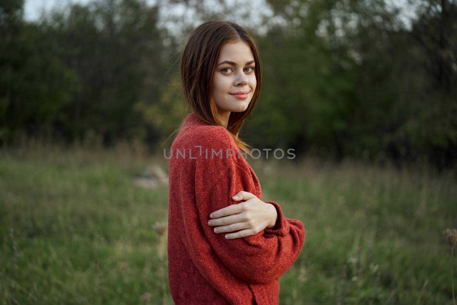 pretty woman in red sweater outdoors walk leisure. High quality photo