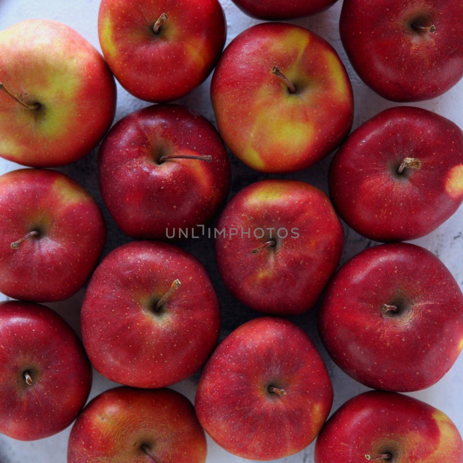 Gyration red ripe apples close-up. From above shot of tasty red apples flat lay