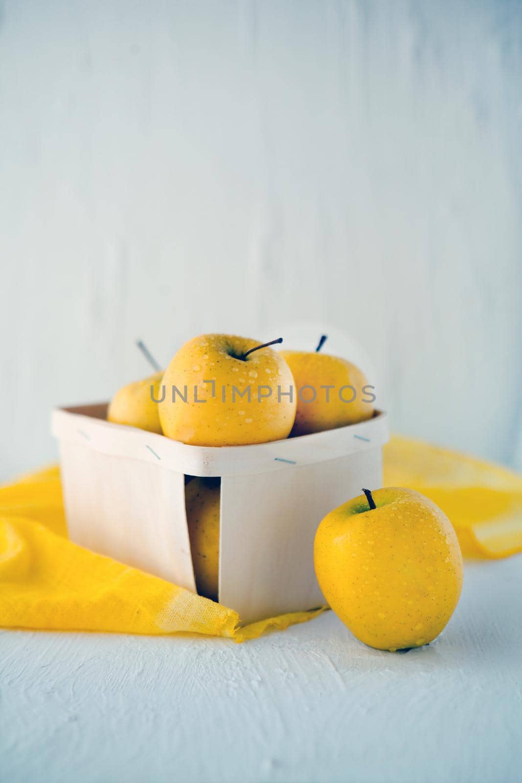 yellow apples at the basket on white background - Symbolic image. Concept for healthy nutrition. Front view.