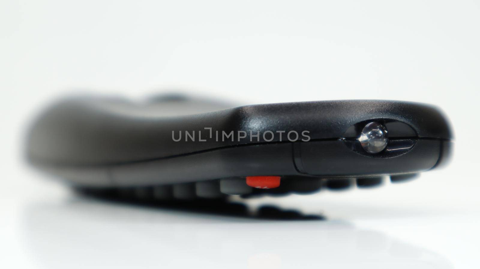 Remote control close-up. Black TV remote control with AAA alkaline batteries on a white background. Battery replacement, spare parts