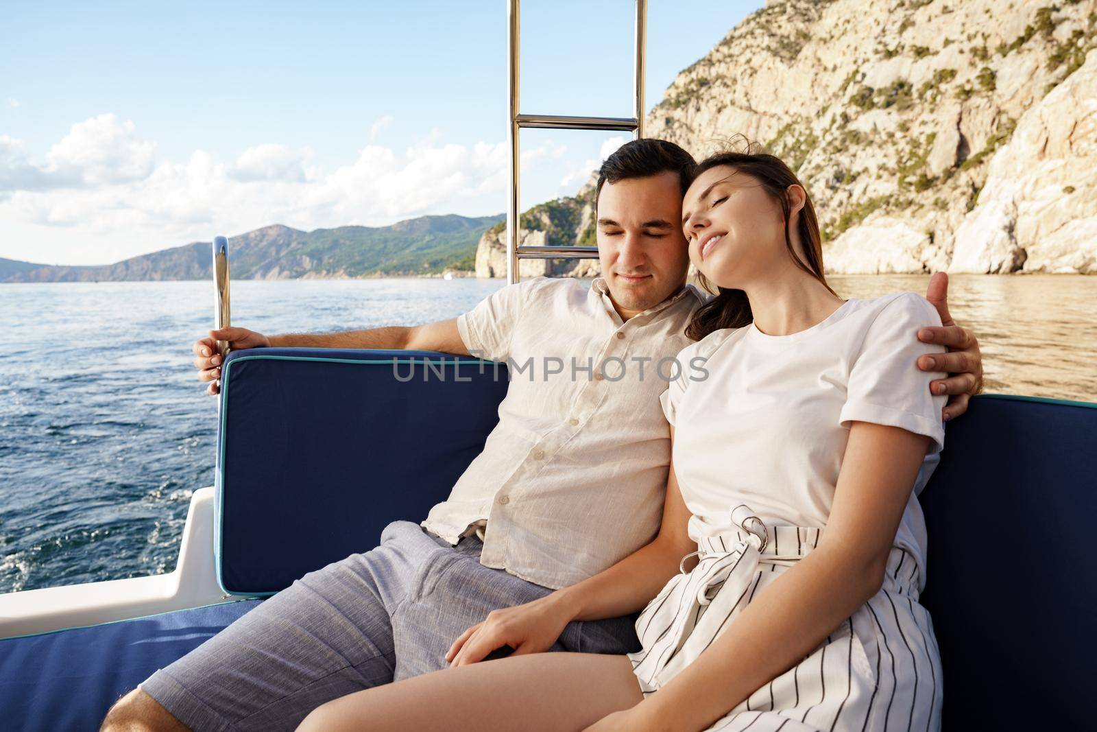 Happy couple on a yacht in summer on romantic vacation by Fabrikasimf