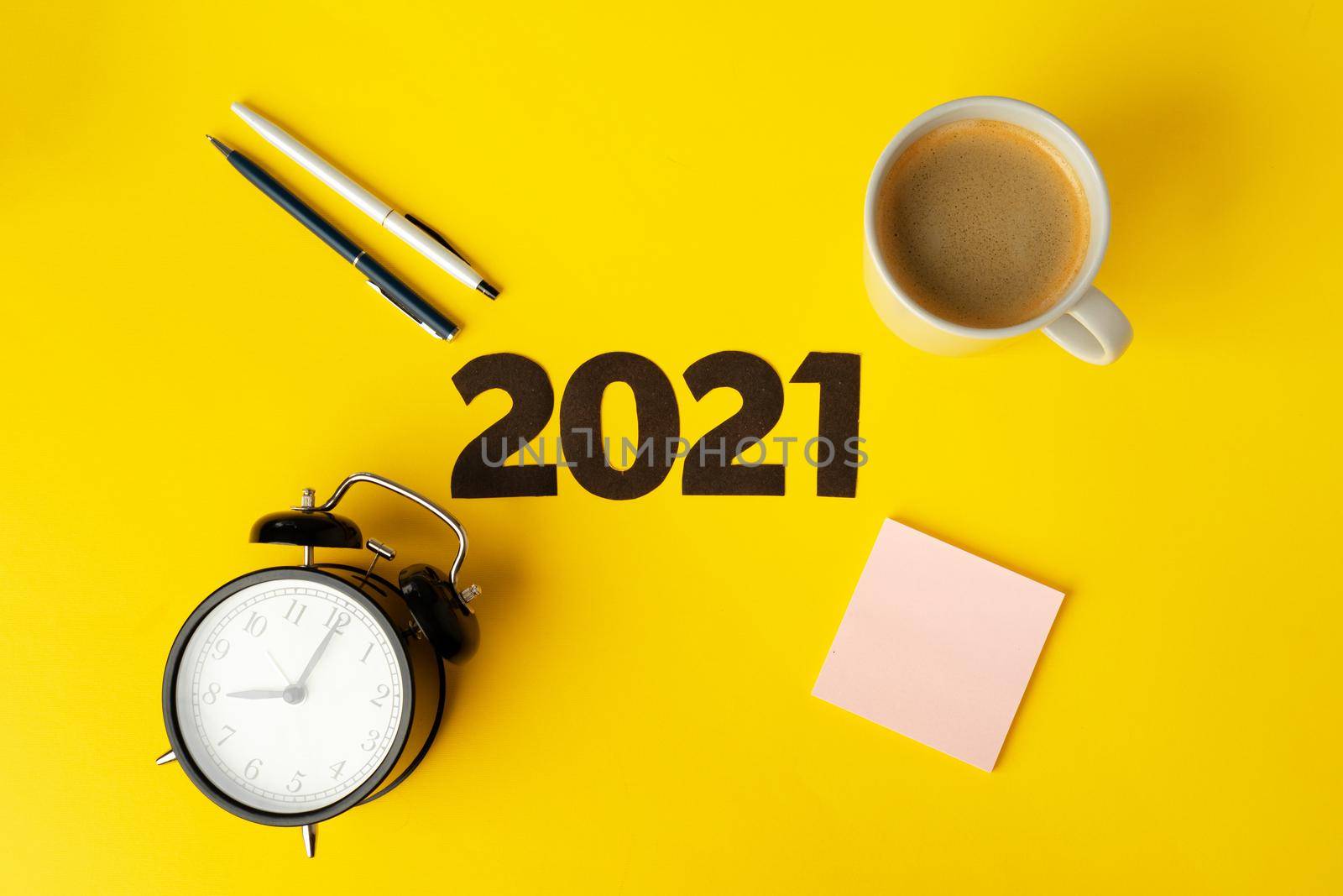 Office supplies and 2021 numbers, top view. New year business goals and plans concept