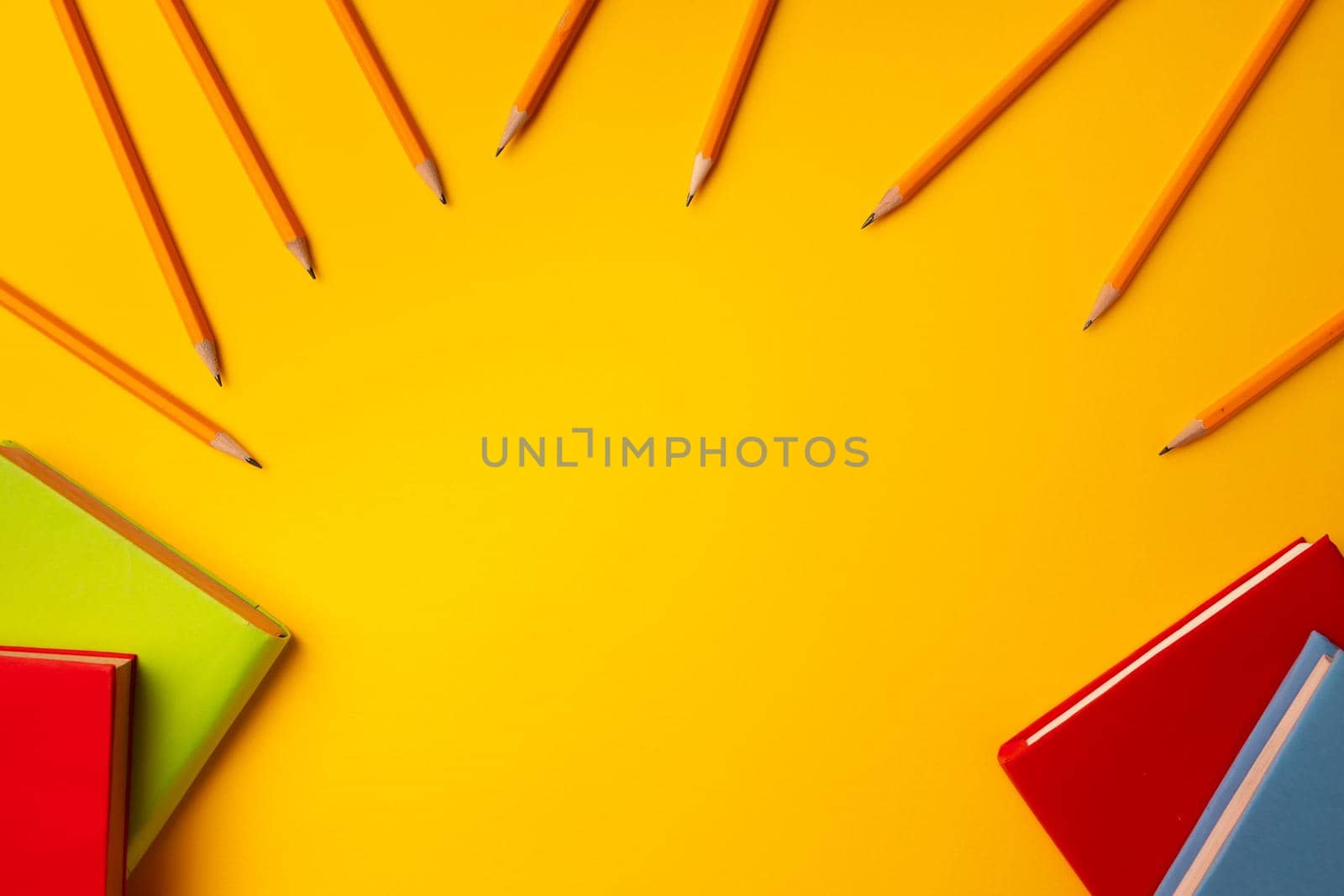 Notepad and color pencils, stationery on working space top view