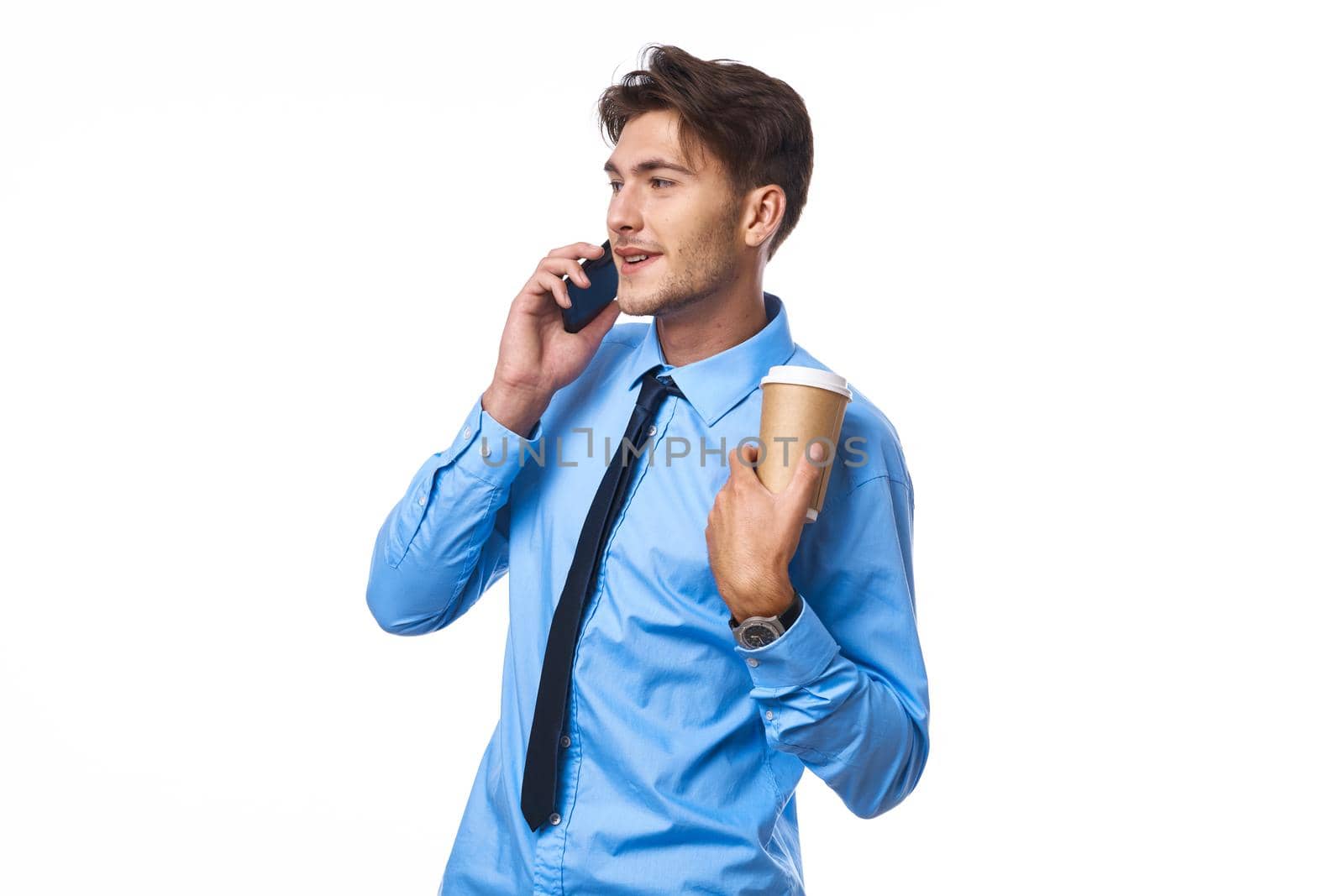 man in shirt with tie communication on the phone a cup of coffee official. High quality photo