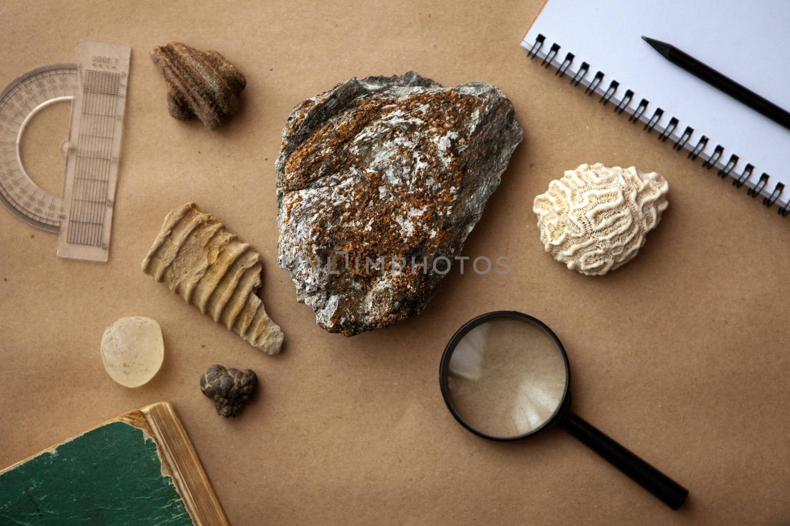 Stone samples, loop, notebook at geological laboratory. Geology rock laboratory. Laboratory for analysis of geological soil materials, stones, minerals, rocks samples for researchers- Brushing samples.