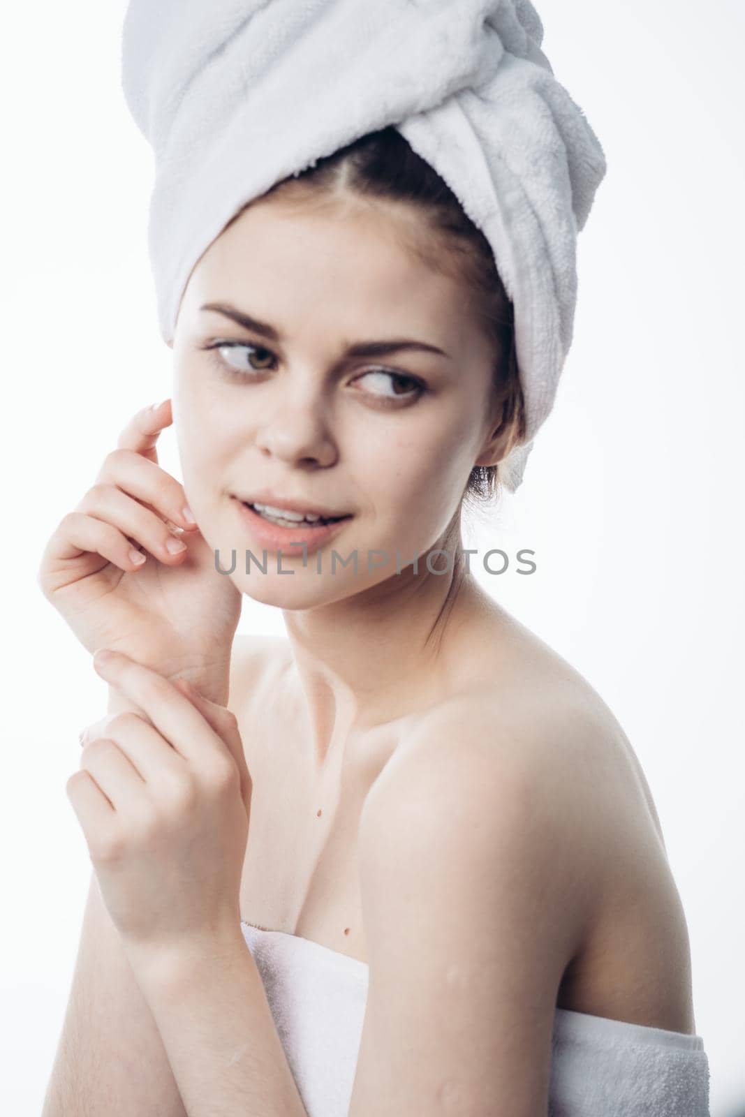 woman after shower with towel on head posing skin care. High quality photo