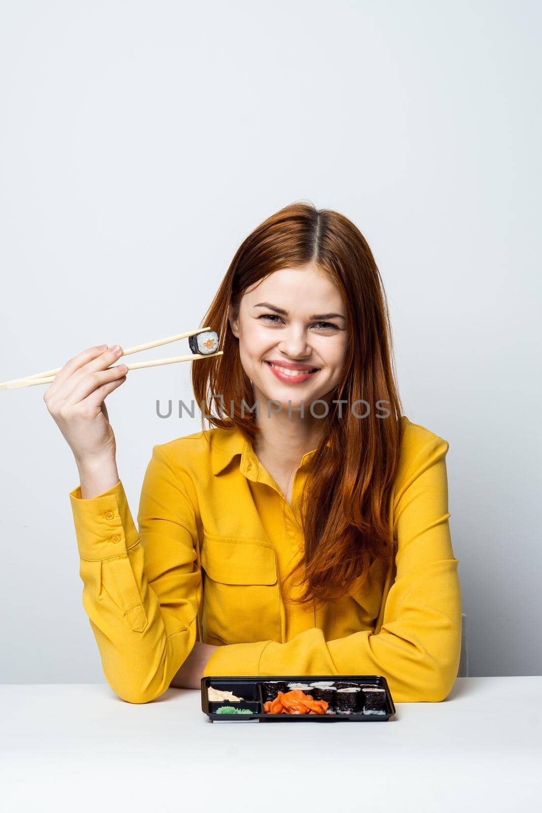 woman at the table eating sushi restaurant japanese snack by Vichizh