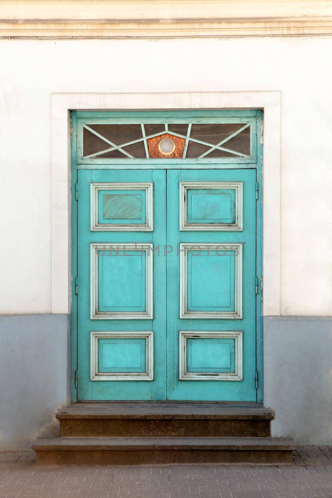 Wooden door with decoration elements in old building facade. Tallinn, Estonia. Colorful timber antique door