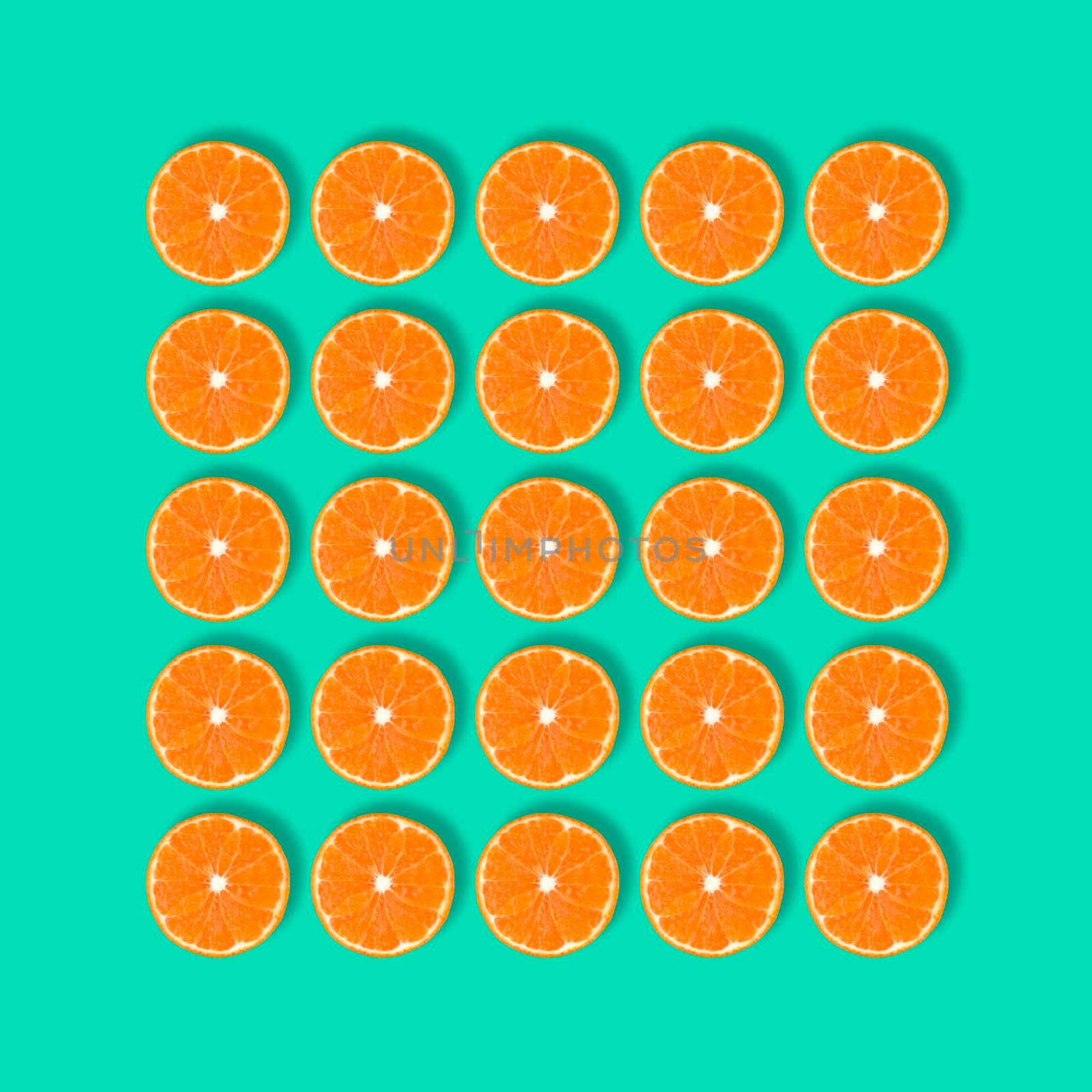 Fruit pattern of fresh mandarin slices isolated on blue or mint background. Flat lay, top view. Pop art design, creative summer concept. Half of tangerine citrus in minimal style.