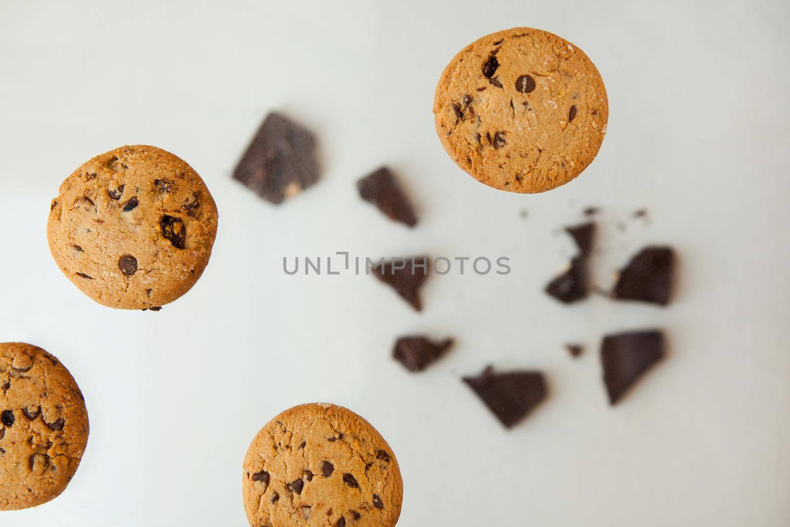 Homemade bakery and dessert. chocolate cookies flying - Chocolate chip cookie with crumbs on gray background.