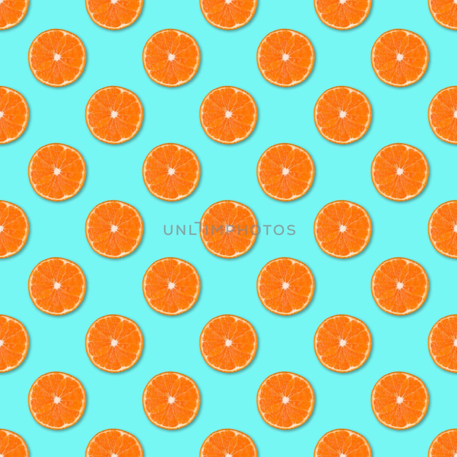 Fresh orange tangerine slices seamless pattern. Close up of citrus fruit on blue background. Studio photography.