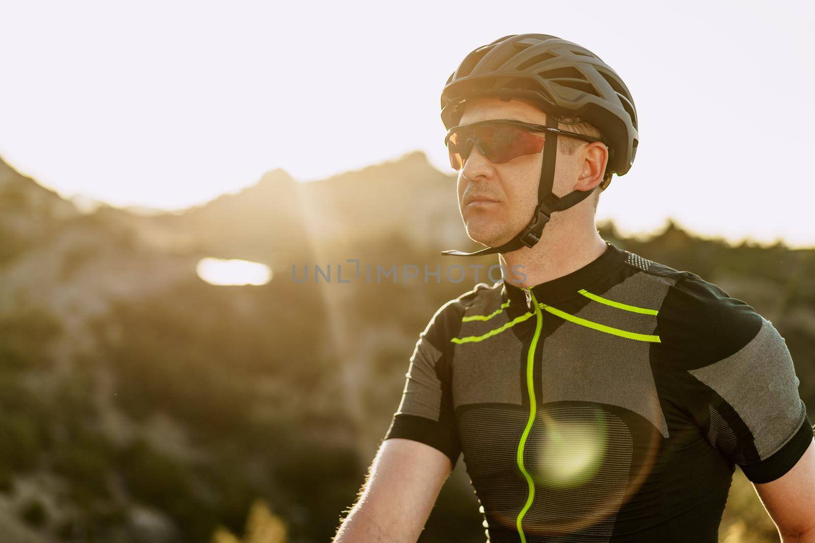 Portrait of male caucasian cyclist with helmet and glasses close up