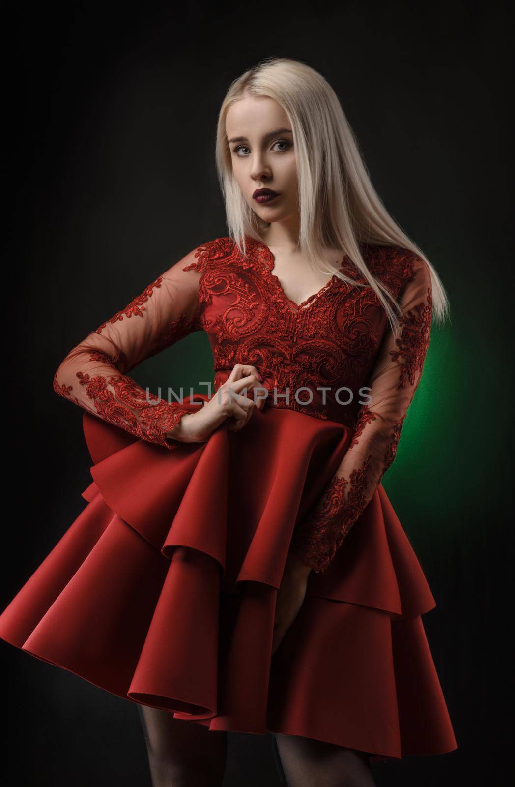 lovely girl in red dress posing on black background in Studio (blonde )