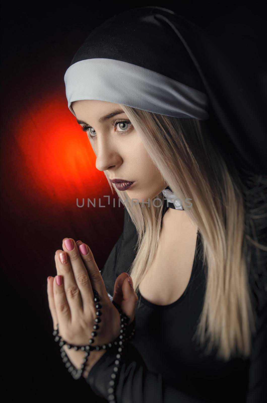Fine art portrait of a novice nun in deep prayer with rosary by Rotozey