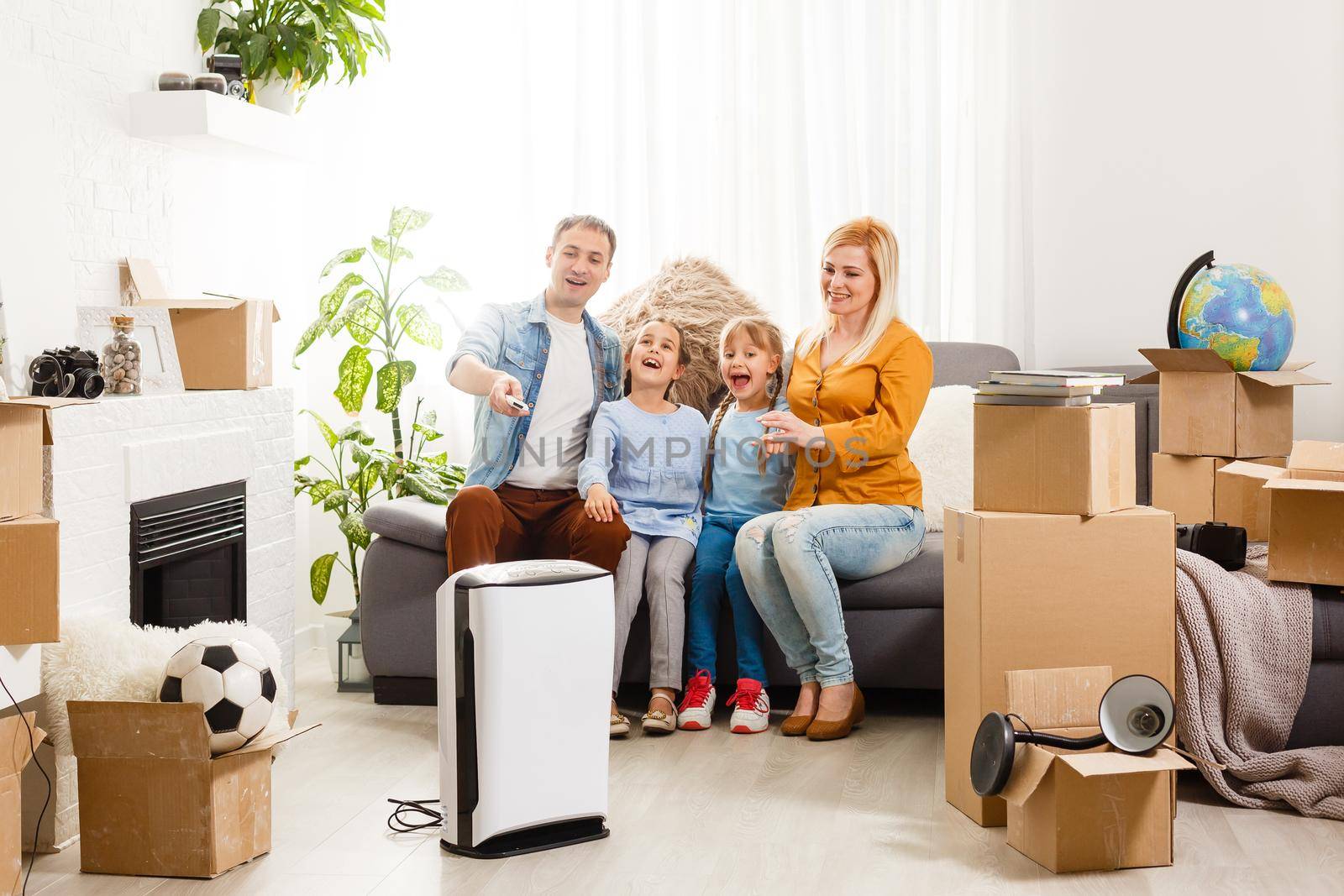 air purifier in living room with happy family moving to new apartment