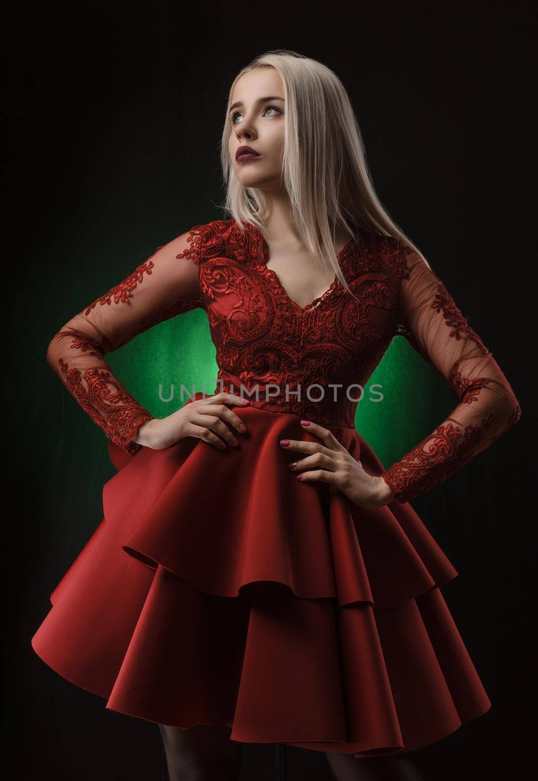 lovely girl in red dress posing on black background in Studio (blonde )