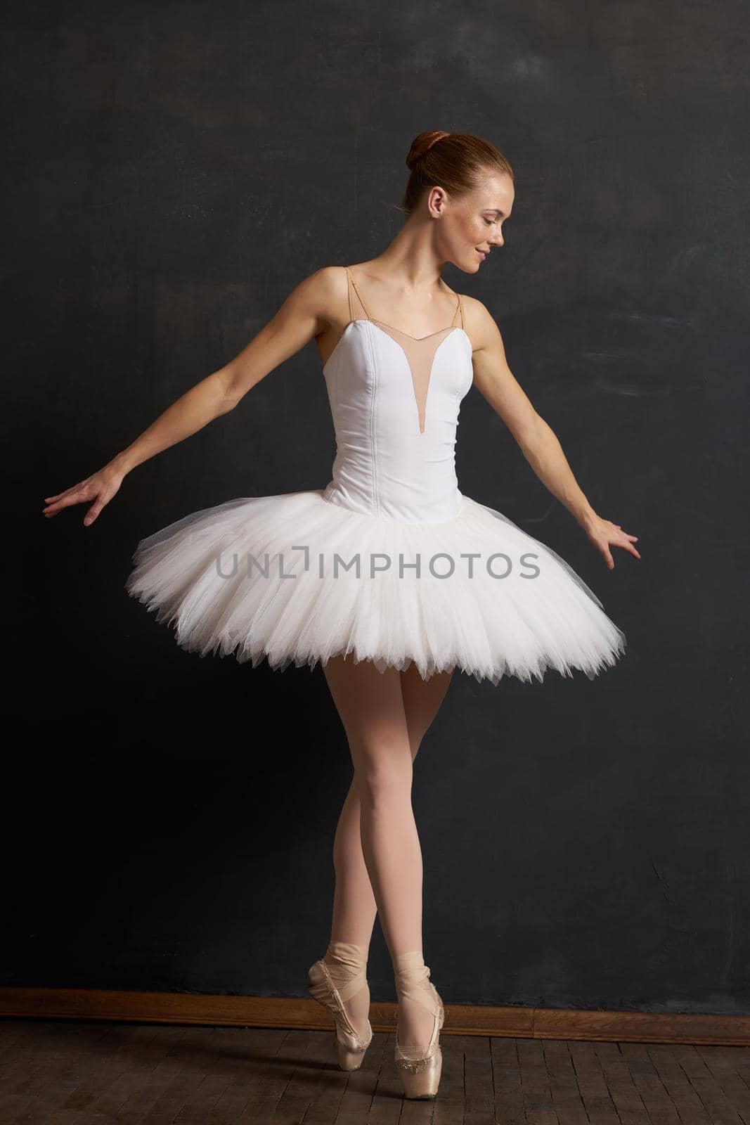 woman ballerina in a white tutu dance posing performance dark background by Vichizh