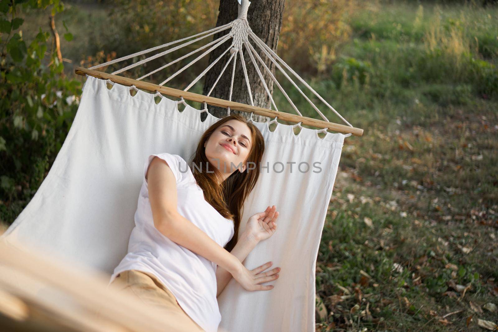 woman relaxing in nature in a hammock garden fresh air by Vichizh