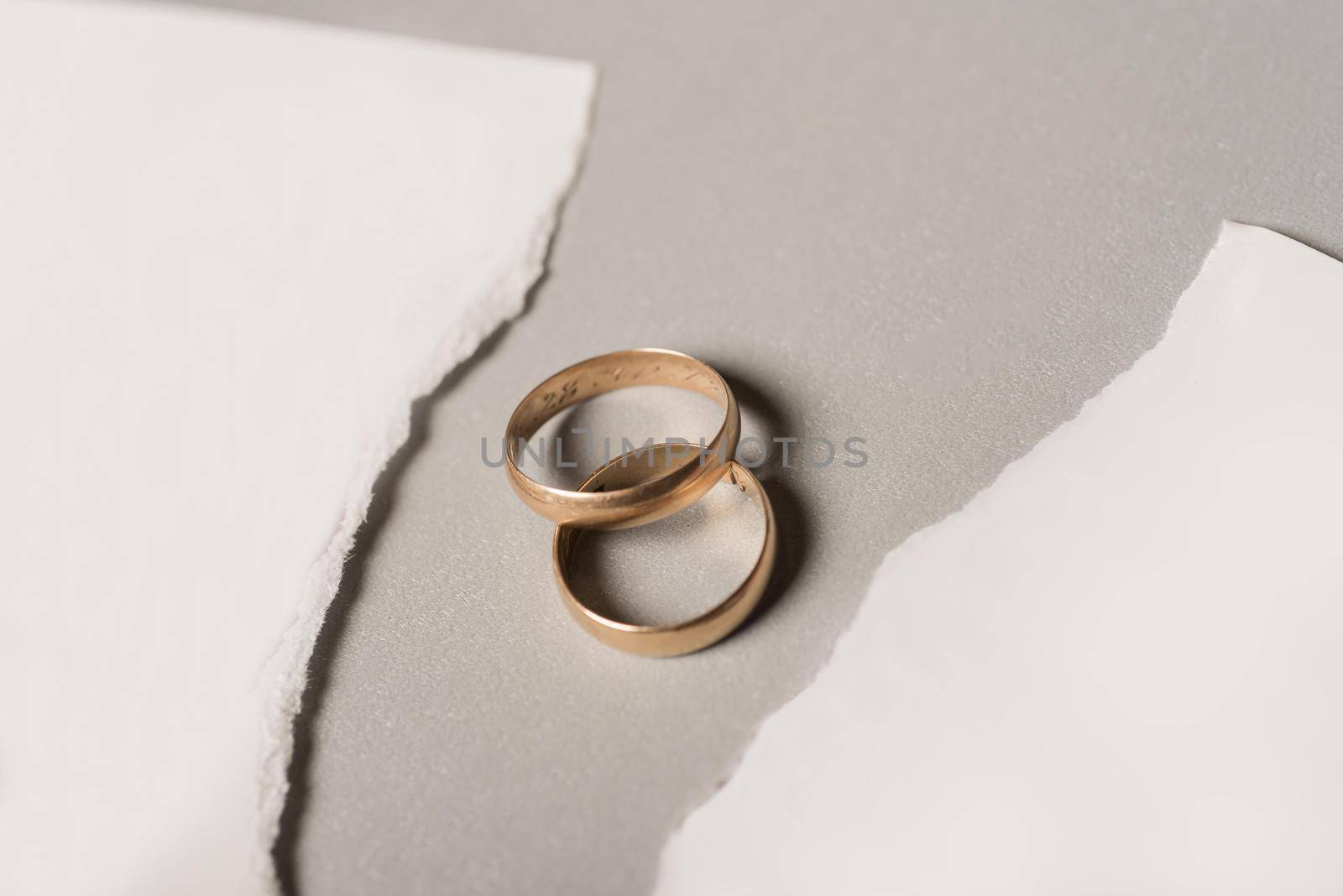 broken paper with golden wedding rings by Zahard