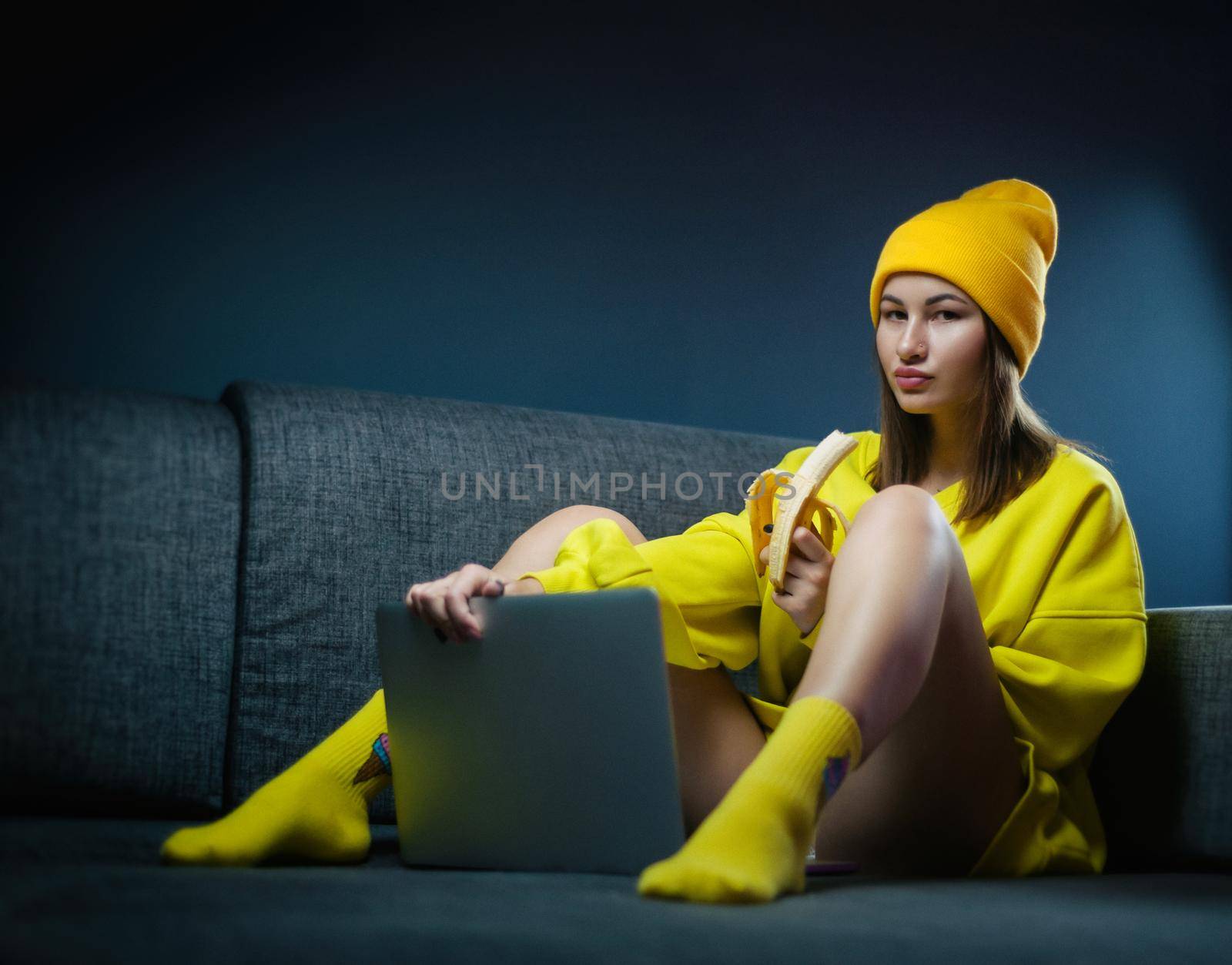 the woman on sofa with laptop eating sexy banana