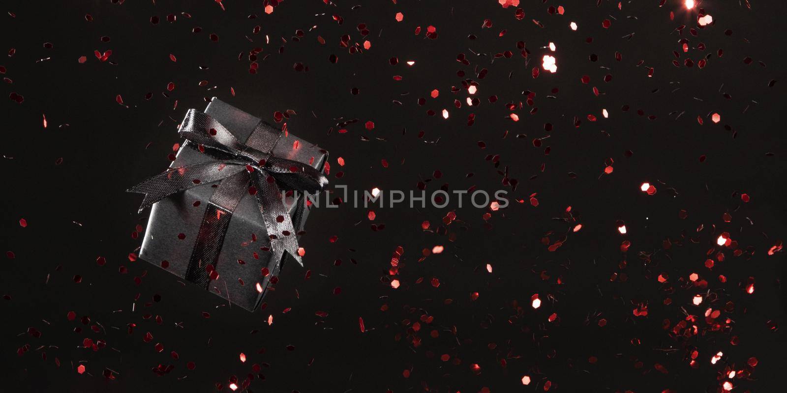 black gift with red glitter black background