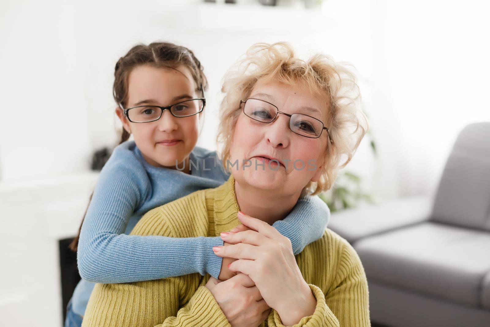 grandmother with granddaughter wearing glasses both