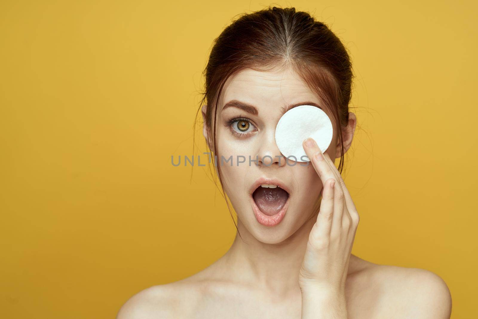 emotional women bare shoulders cotton pads and clear skin attractive look. High quality photo