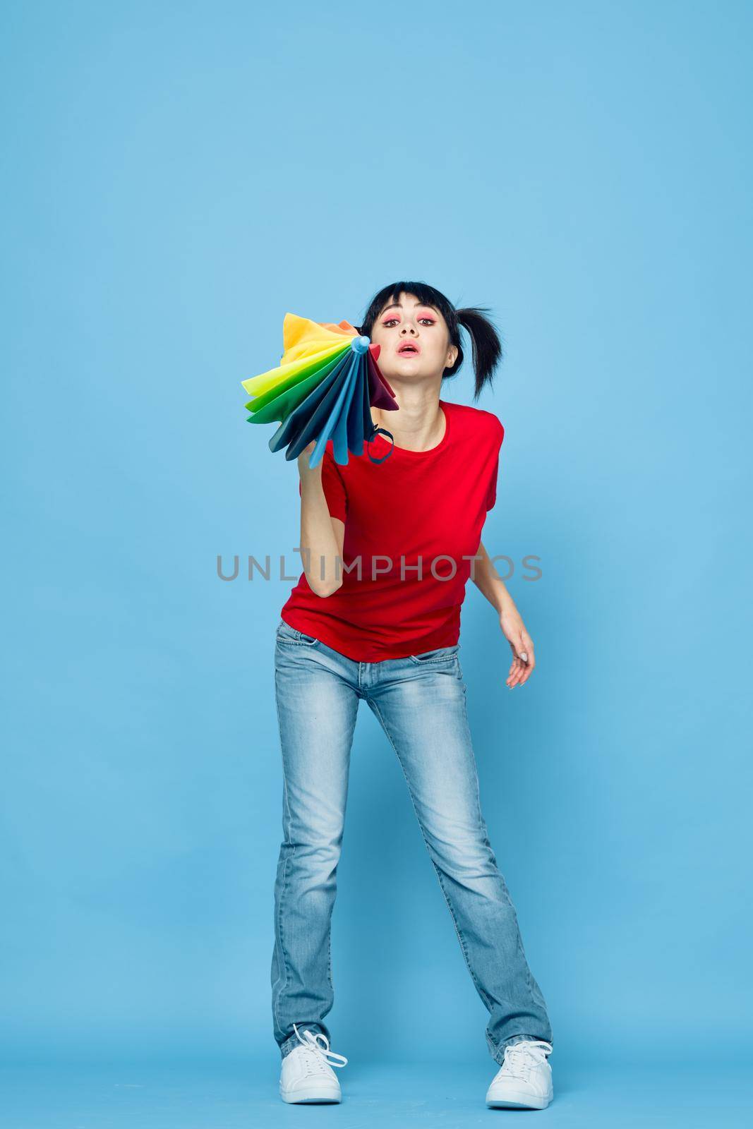 cheerful woman in red t-shirt rainbow color umbrella fashion. High quality photo