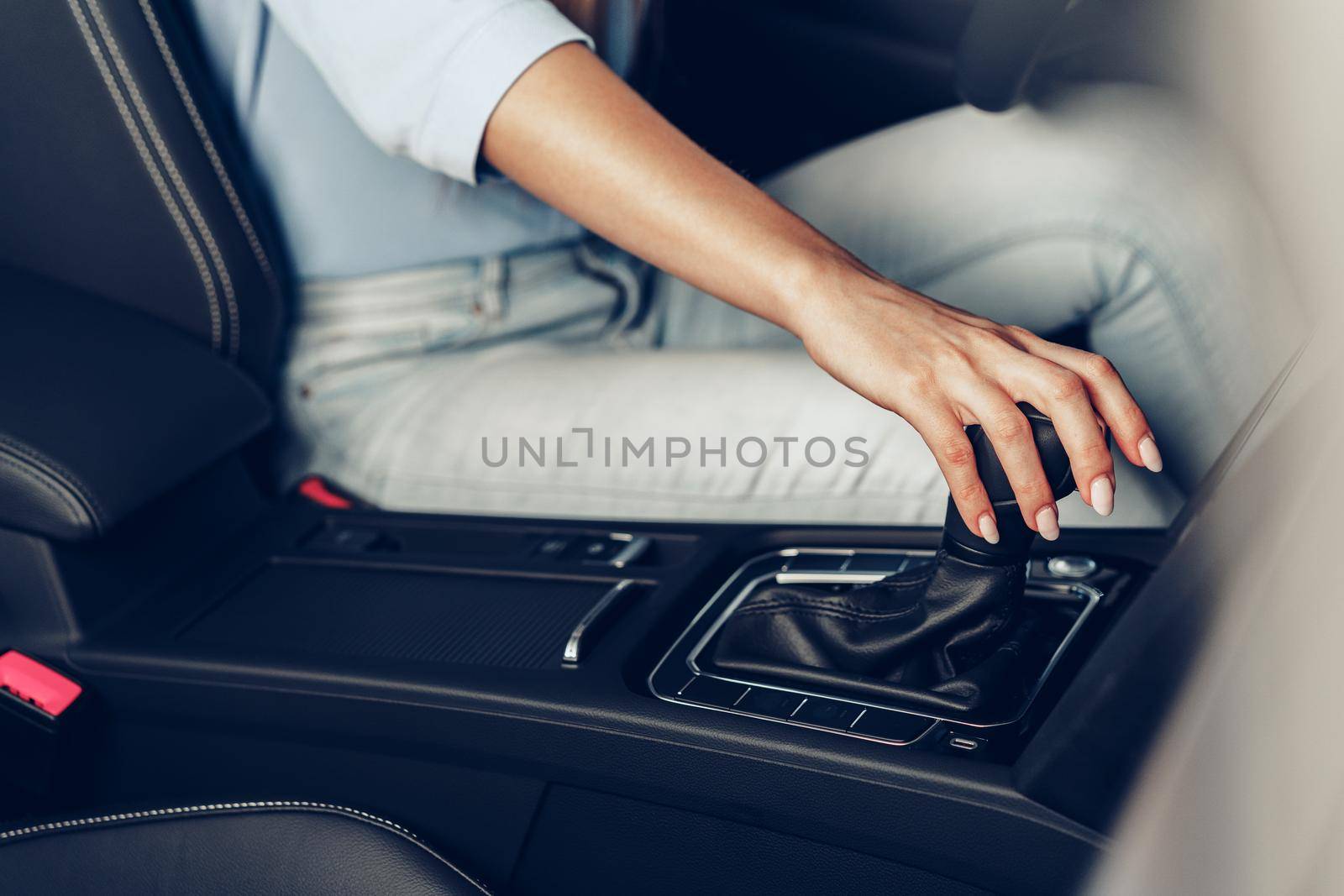 Female hand on gear lever in a car close up